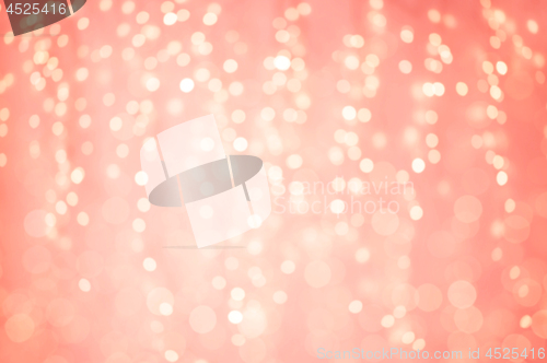 Image of blurred bokeh lights in living coral color