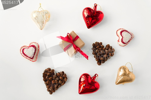 Image of christmas gift and heart shaped decorations