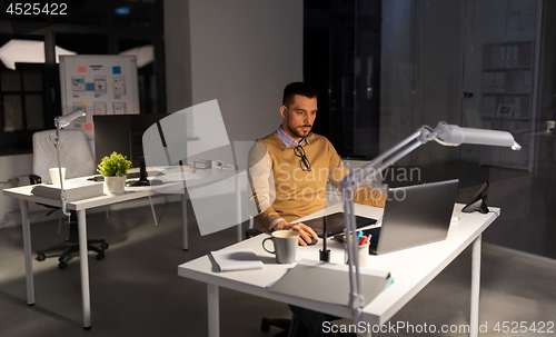 Image of designer with computer and pen tablet at office