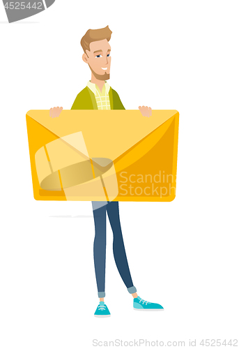 Image of Young caucasian businessman holding big envelope.
