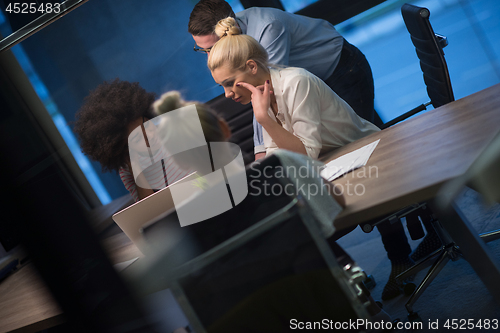 Image of Multiethnic startup business team in night office