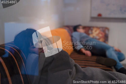 Image of software developers sleeping on sofa in creative startup office