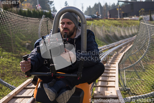 Image of videographer at work on alpine coaster