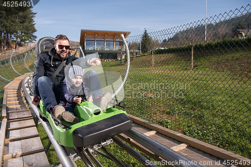 Image of father and son enjoys driving on alpine coaster