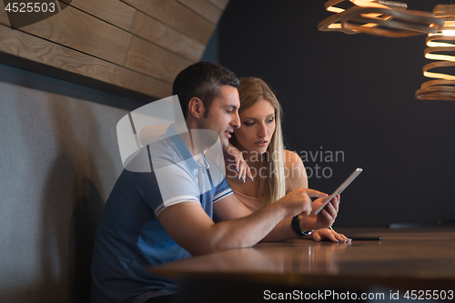 Image of couple using tablet at home