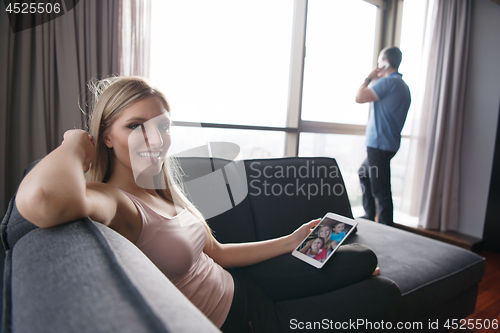 Image of woman using tablet in beautiful apartment
