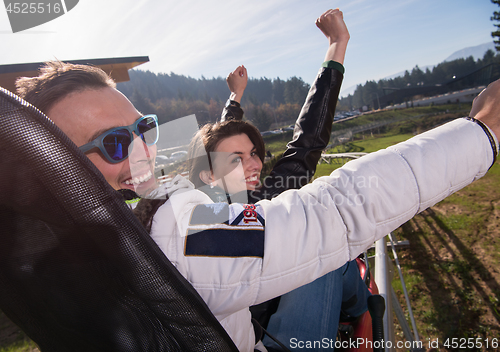 Image of couple enjoys driving on alpine coaster