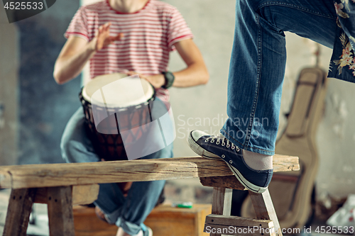 Image of Repetition of rock music band. drummer behind the drum set.