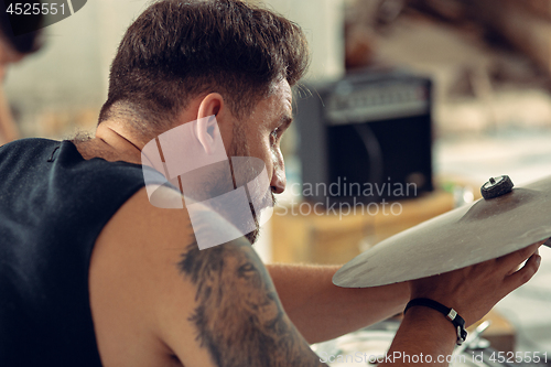 Image of Repetition of rock music band. drummer behind the drum set.