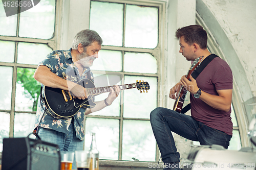 Image of Repetition of rock music band. Electric guitar players