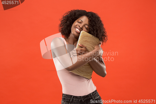 Image of The happy businesswoman with laptop on red