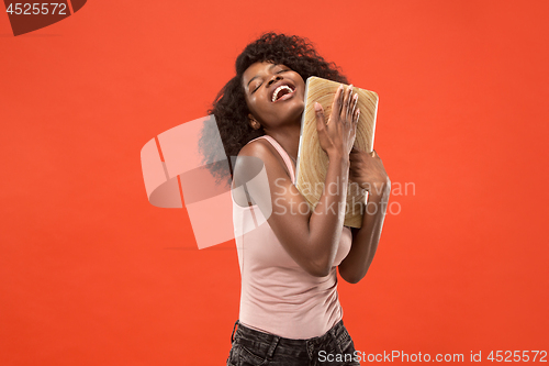Image of The happy businesswoman with laptop on red