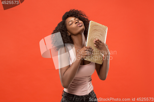 Image of The happy businesswoman with laptop on red
