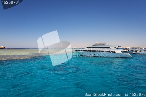 Image of Luxury yacht docking near coral reef