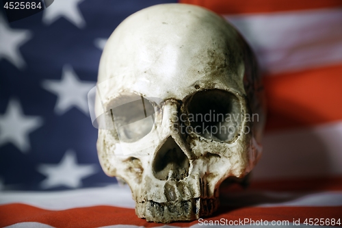 Image of Human skull against american flag