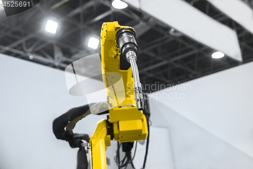 Image of Automatic robot arm working in industrial environment