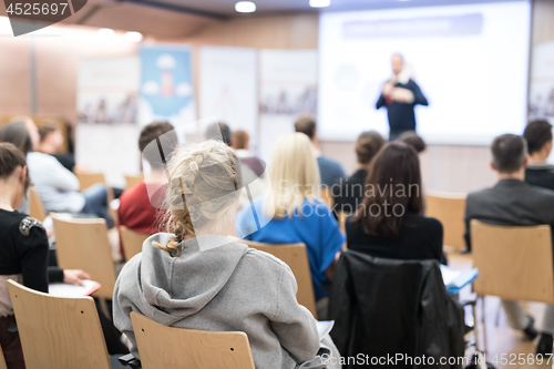 Image of Business speaker giving a talk in conference hall.