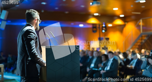 Image of Public speaker giving talk at business event.