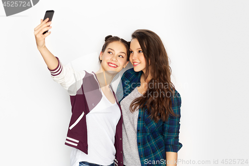 Image of happy teenage girls taking selfie by smartphone