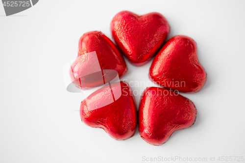 Image of close up of red heart shaped chocolate candies