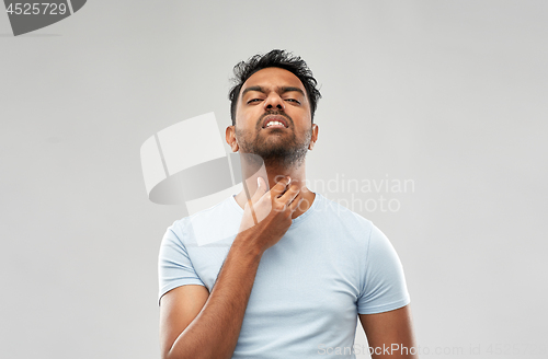 Image of indian man suffering from neck pain or sore throat