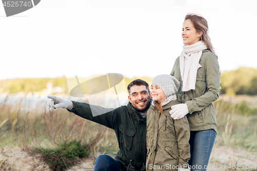 Image of happy family on autumn beach