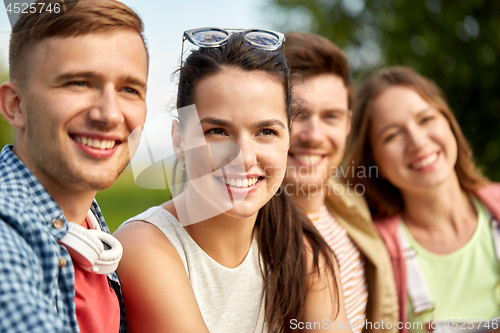 Image of happy teenage friends outdoors in summer