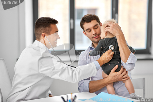 Image of father with baby and doctor at clinic