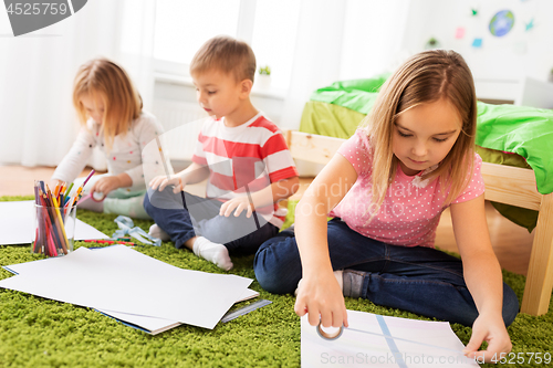 Image of children drawing and making crafts at home