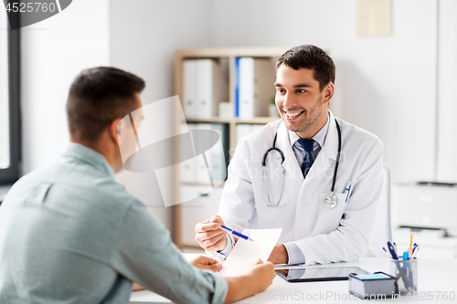 Image of doctor showing prescription to patient at hospital