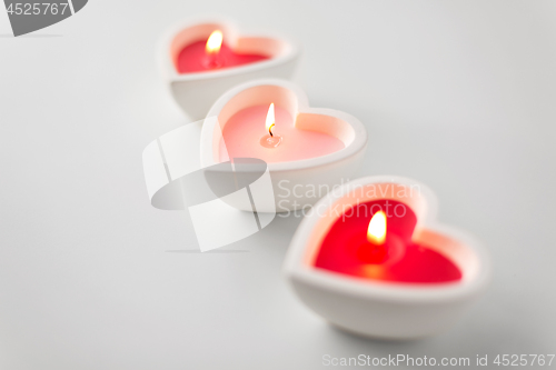 Image of heart shaped candles burning on valentines day