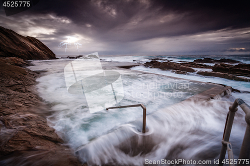 Image of Turbulent ocean, big swell and surging rock pool overflows