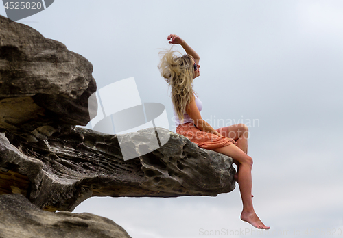 Image of Woman tossing her hair in the outdoors
