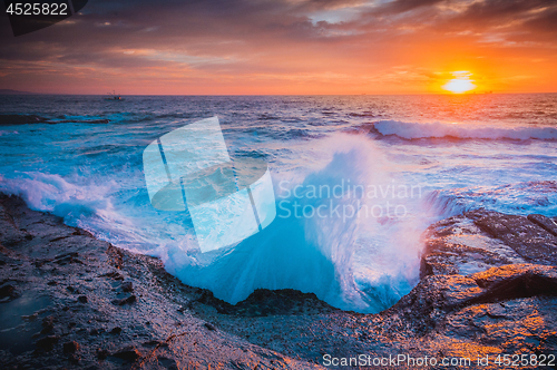 Image of The whooosh of waves as they break over the coastal rocks