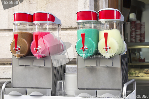Image of Four flavors of grenadine ice for sale on the street