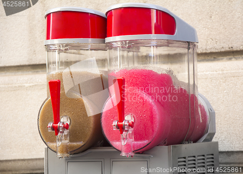 Image of Two flavors of grenadine ice for sale on the street