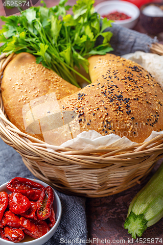 Image of Homemade pizza calzone in a wicker basket.