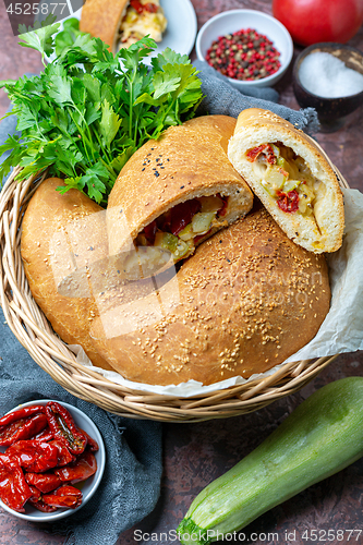 Image of Fresh calzone pizza in a wicker basket.