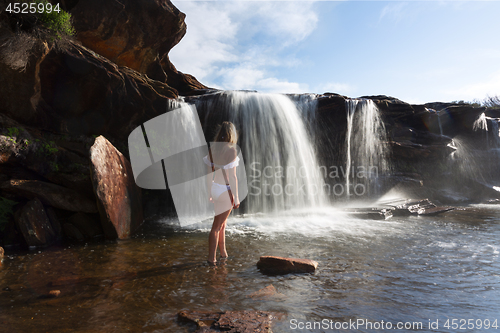 Image of Female exploring and enjoying waterfalls and rock pools in nature