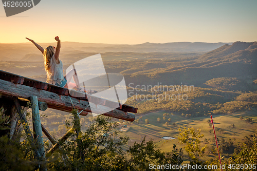 Image of Freedom loving woman feeling exhilaration on ramp high above the valley