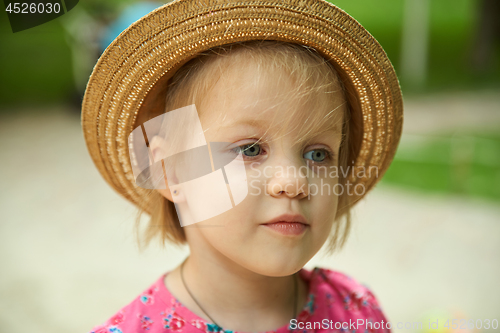 Image of Cute kid girl wearing hat outdoors