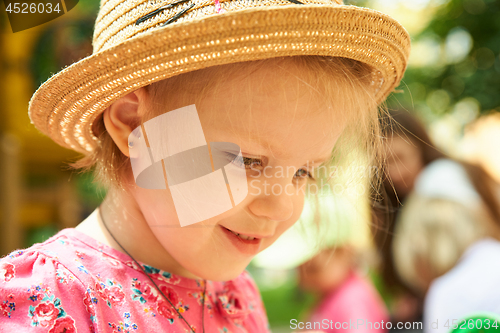 Image of Preschool girl in straw hat