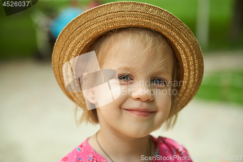 Image of Cute kid girl wearing hat outdoors