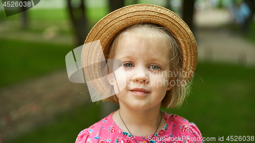 Image of Cute kid girl wearing hat outdoors