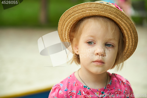 Image of Cute kid girl wearing hat outdoors