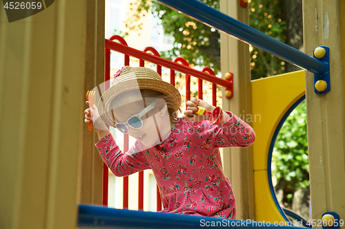 Image of Portrait of laughing little girl in stawn hat