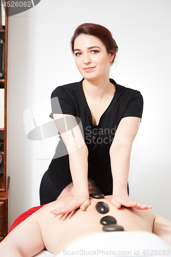 Image of Young woman getting back massage