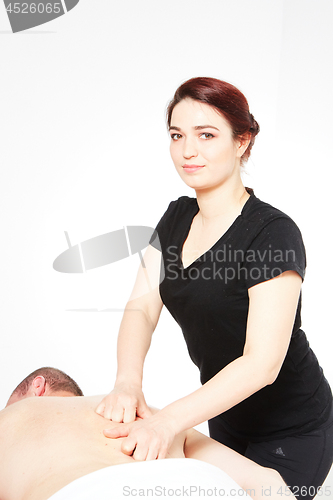 Image of Young woman getting back massage