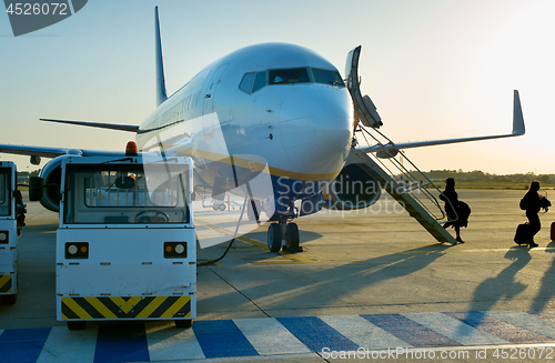 Image of Passengers leave airplane at airport