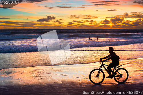 Image of Cycling on the beach, silhouette